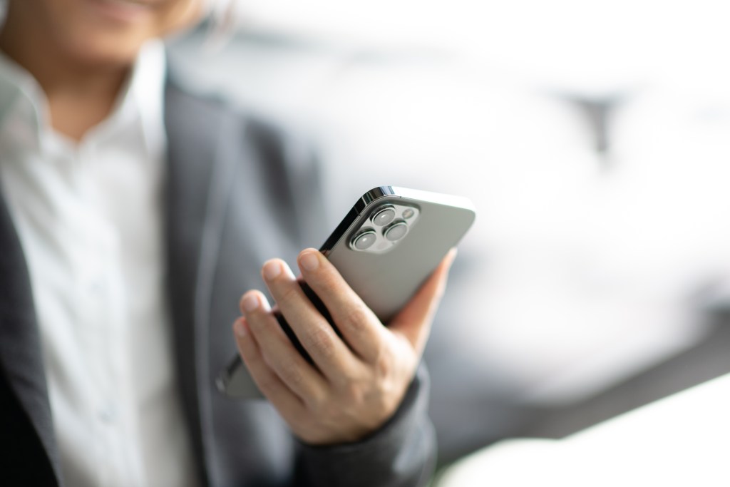 Businessman holding an iPhone 12 Pro Max Black in Bangkok, Thailand
