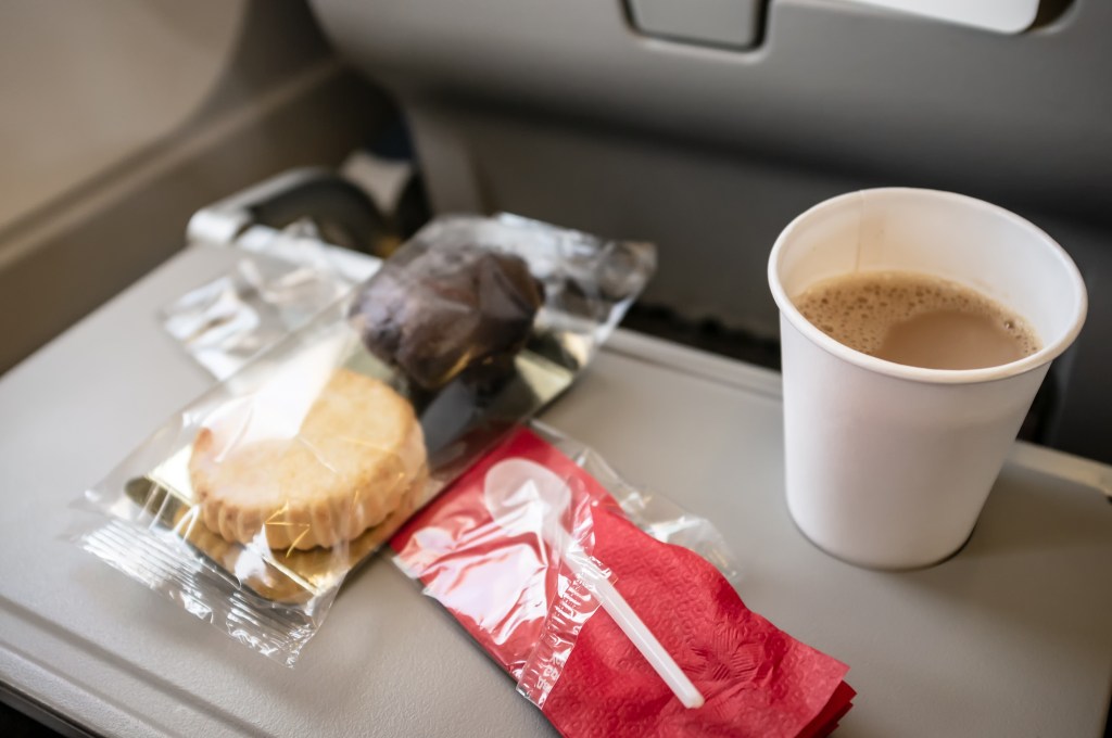 Snack plane and brown on a tray table.
