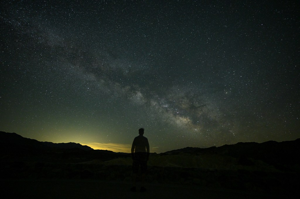 Man watches Galaxy and Sunrise Way Milky in the dark sky