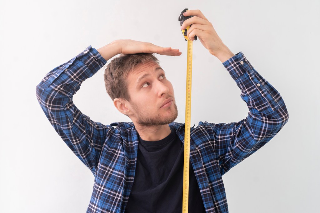 The man who measures his height with a mass of tape.