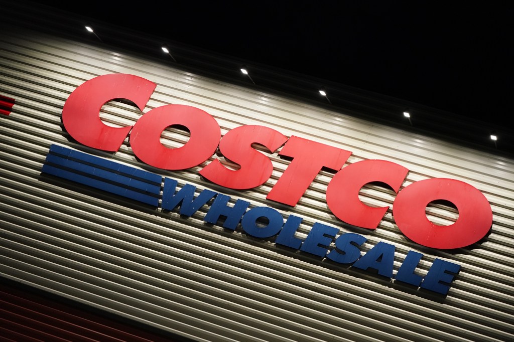 Wholesale Costco signs at night.