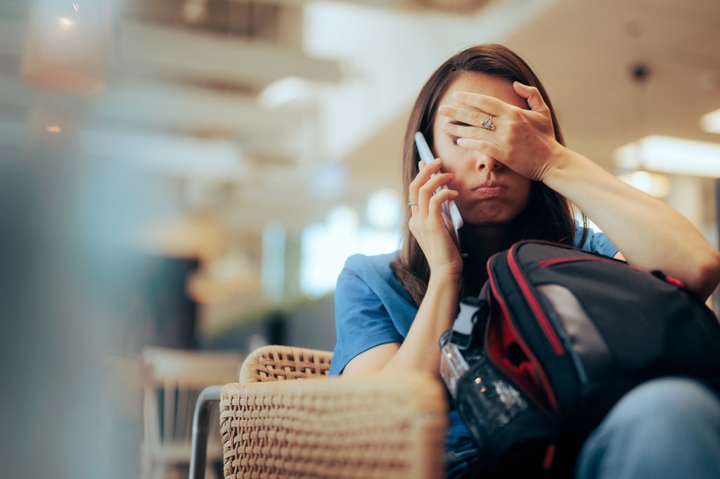Bored woman on the phone at the airport.