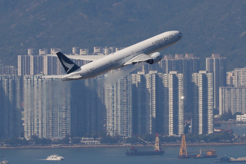 Cathay Pacific plane by rising over Hong Kong.