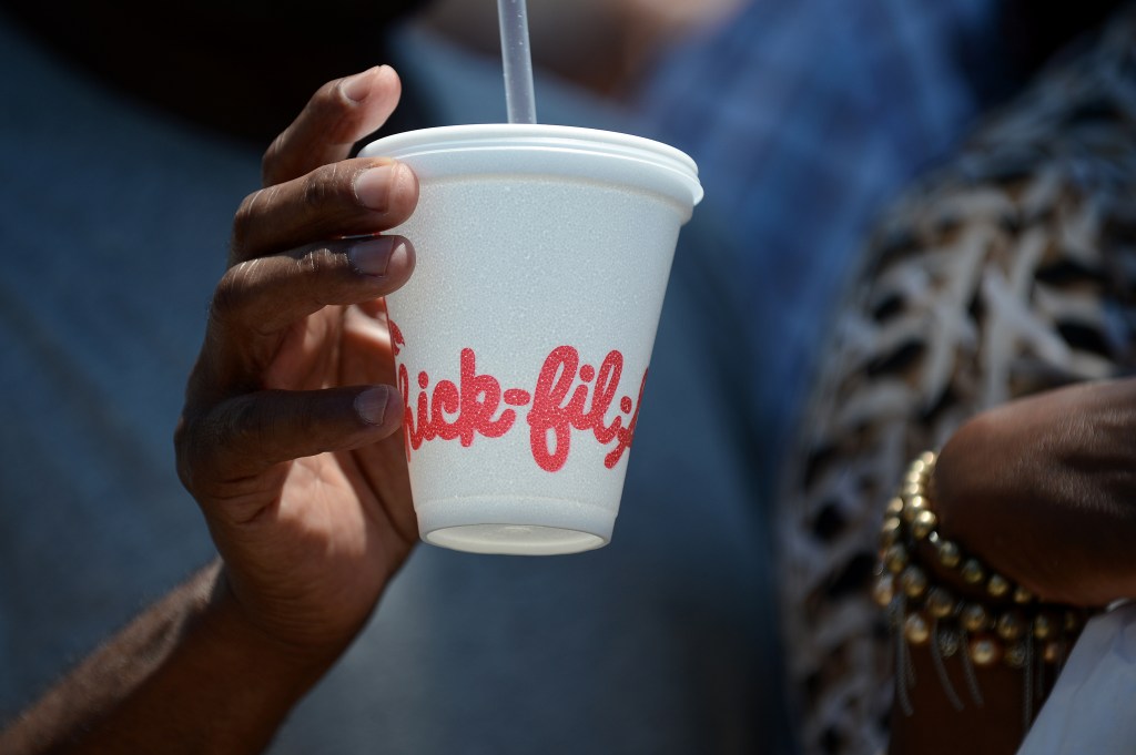 A man carries him to drink outside a fast food restaurant of Chick-Fil-A in Hollywood, California 1 August 2012.