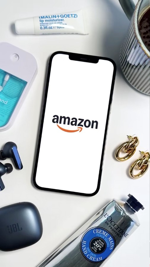 Smartphone featuring the Amazon logo surrounded by various personal care and technology articles.