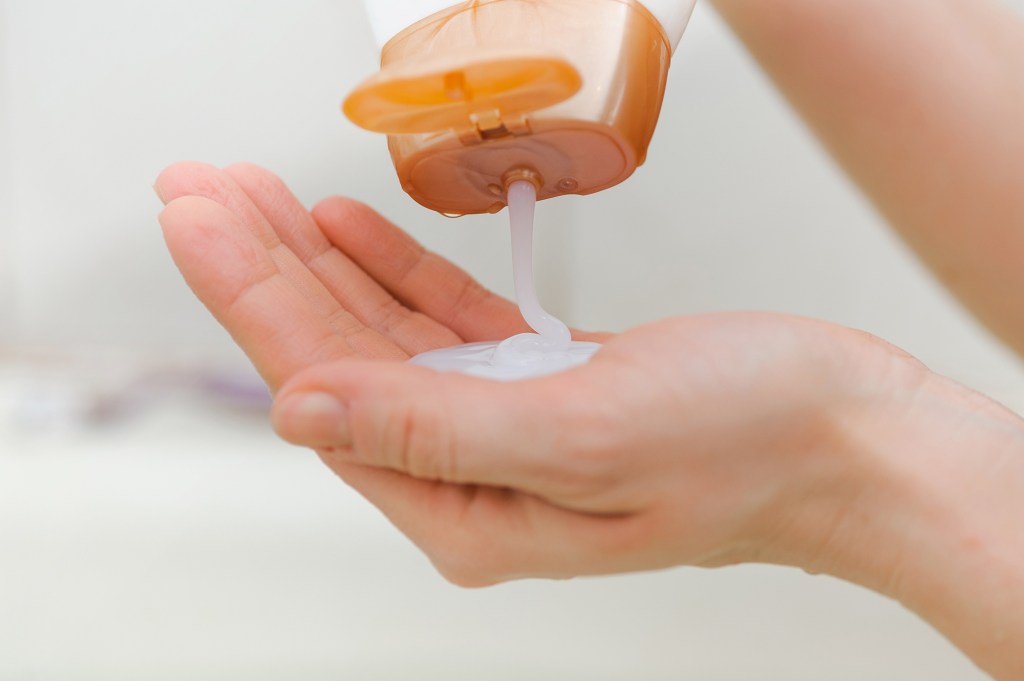 Liquid soap is pouring into one hand.